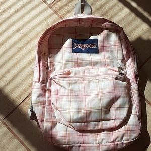 Pink, white, and tan jansport backpack